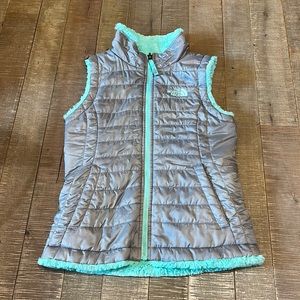 EUC North Face kids faux fur-lined reversible vest in gray and mint green.